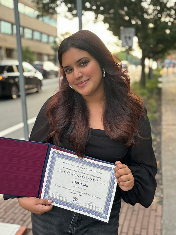 Sristi Halder '26 celebrates her certificate of completion.
