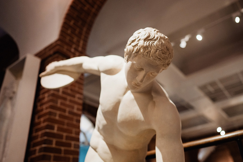 A cast of an ancient statue showing a man in the midst of throwing a discus at the Wright Museum of Art at Beloit College.