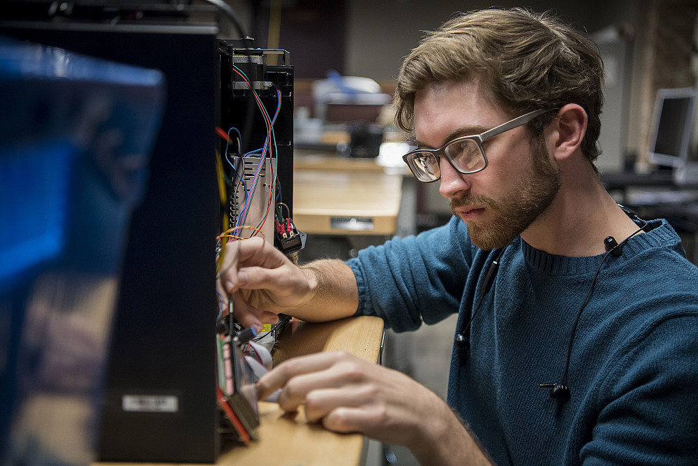 A Beloit College student works on a series of electronic components.