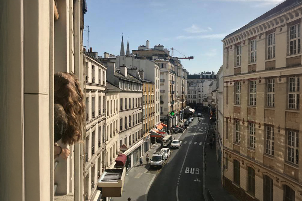 Beloit College student Kaija Groom viewing out a window in the city of Paris, France.