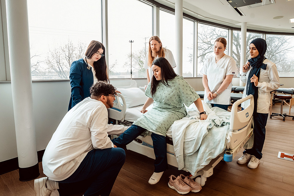 Beloit College students practice medical techniques.