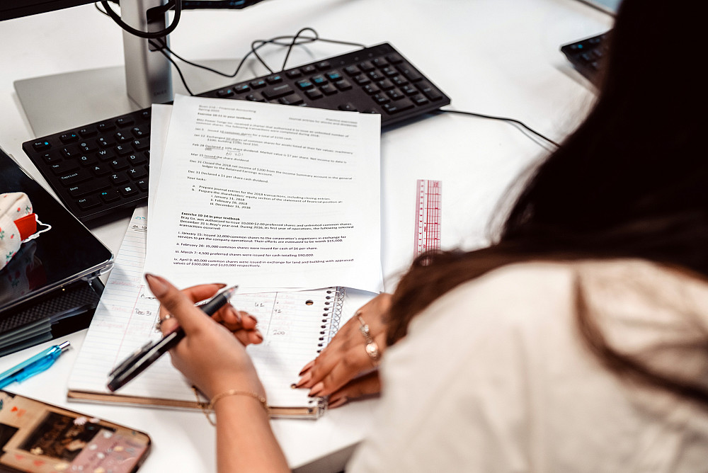 A Beloit College student works through finance examples involving stock options.
