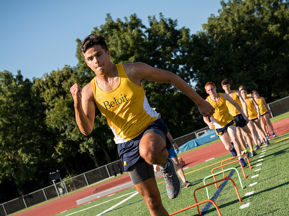 Members of Beloit College's Track and Field team take turns doing high-step excercises.