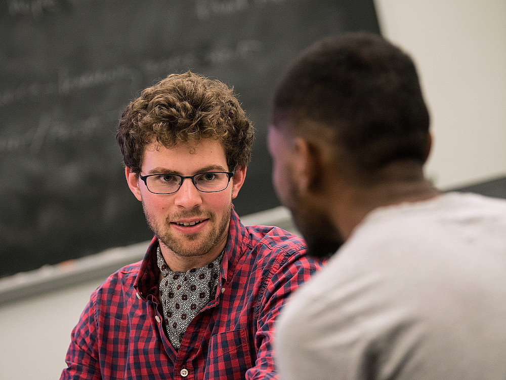 Two Beloit College students talk together during a class discussion.