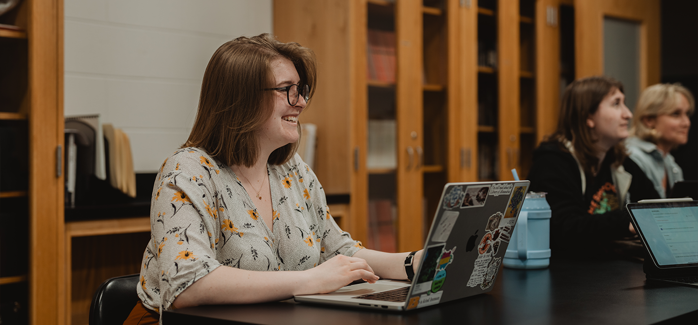 A student smiling during a presentation.