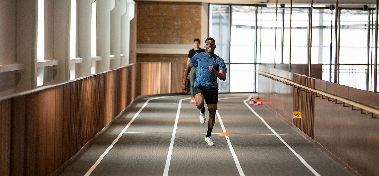 A student run down the track at the Powerhouse in an race.