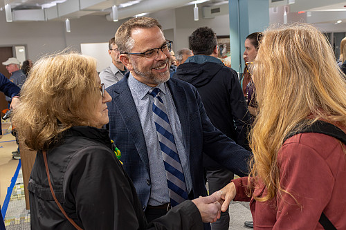 Beloit College President Eric Boynton greets members of the community.