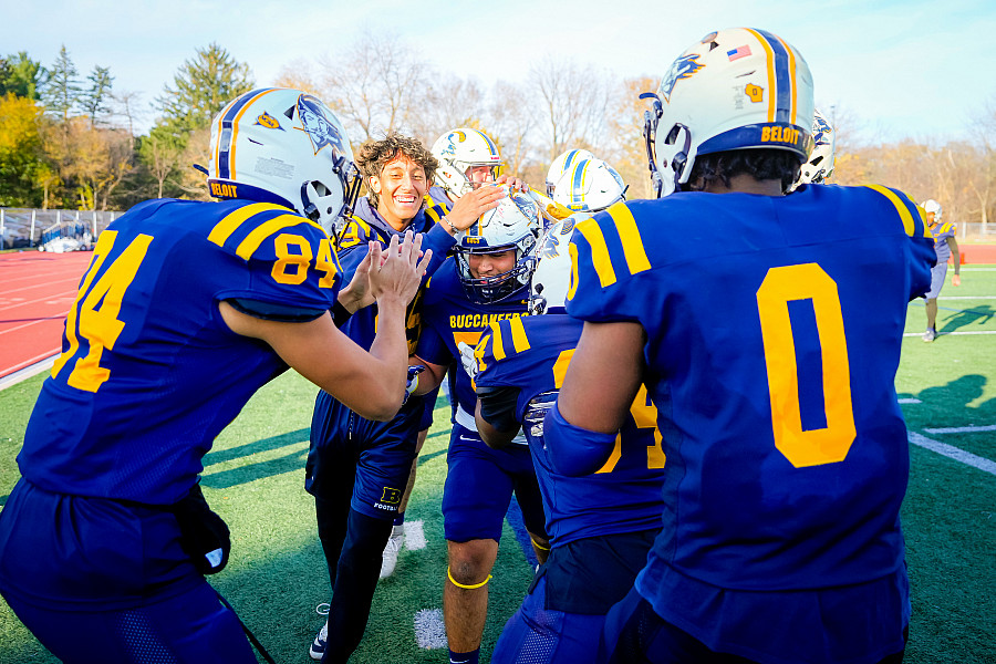 Football teammates congratulate a player after a good play.