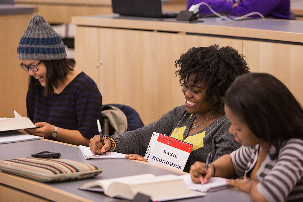 Here, a student is seen hitting the books in an economics class/lecture.
