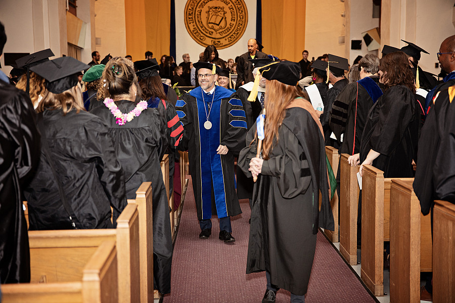 President Eric Boynton shakes hands with the crowd during the ceremony recessional.