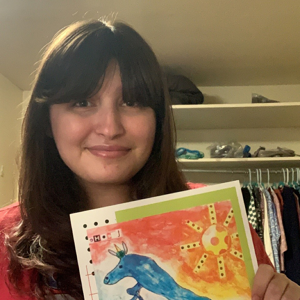Sydney Moses'25 holding a copy of Parakeet Magazine containing her first published poem.