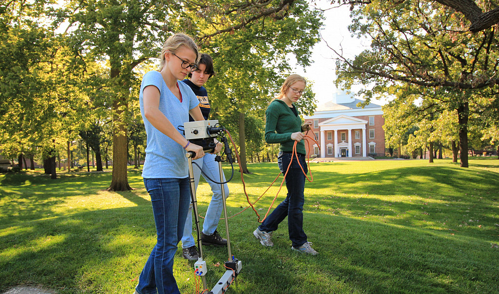Beloit archaeology students pass a ground imaging machine over one of the ancient Indian mounds on campus.