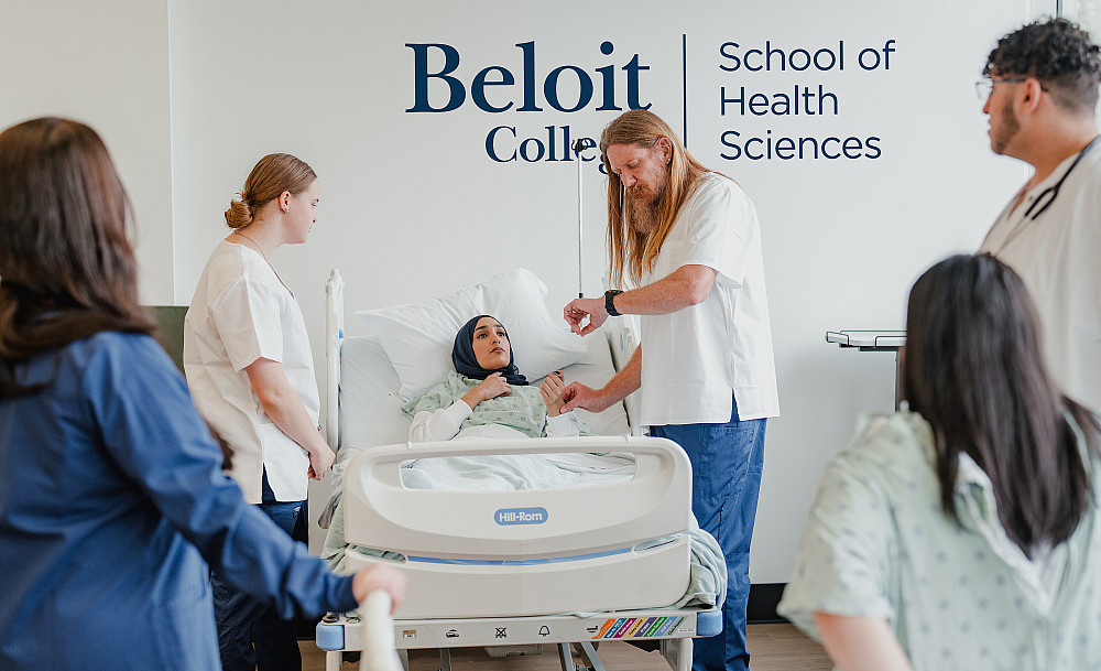 Nursing program students observe as the heart rate of a patient is timed in the Beloit College Skills Lab.