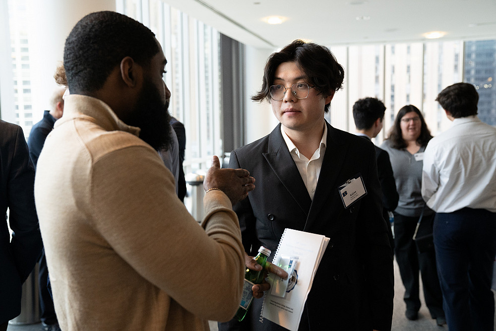 A student and alumni talk together at the 2024 Business Networking Summit.