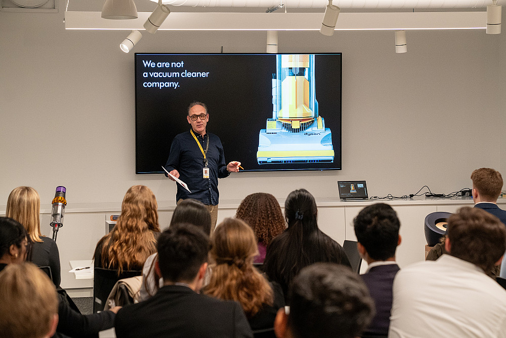 A Dyson representative talks to students during the 2024 Business Networking Summit.