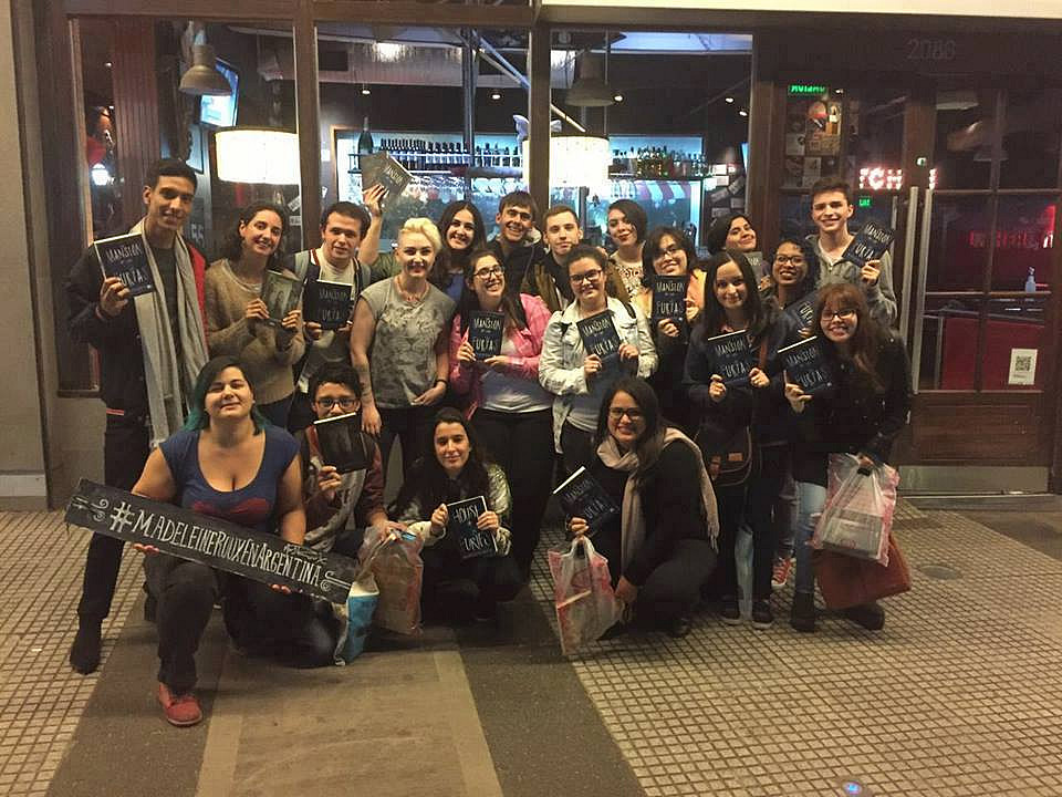 Fans are holding copies of her book House of Furies in both English and Spanish