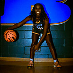 Alexis Ross dribbling a basketball.