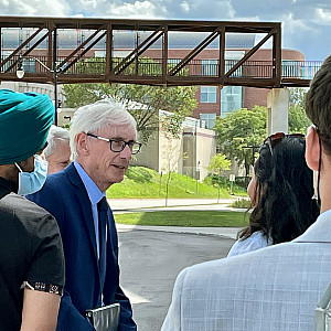 Governor Tony Evers greets students during an event honoring the energy efficiency of the Powerhouse.