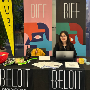 My Le’25 poses while tabling for the Beloit International Film Festival (BIFF) as an Impact Beloit Community Fellow.