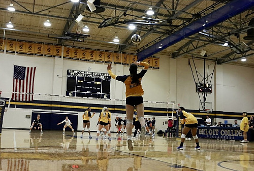 Serving on the court at a Bucs volleyball game.