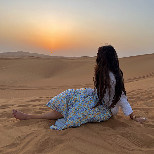 Ariana lounging in the sand in the United Arab Emirates.