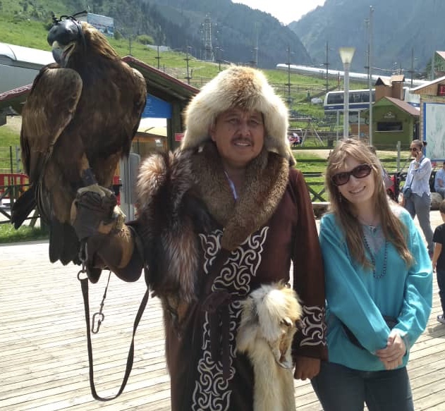 Kathleen Connell'20 stands with a Kazahk eagle hunter near Almaty, Kazakhstan