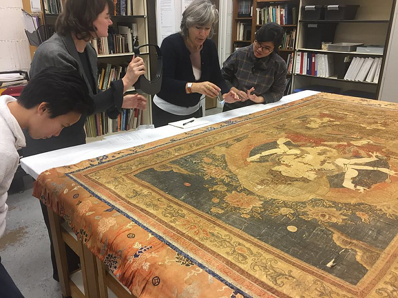 Wright Museum of Art Director Joy Beckman, ConservatorMarion Boyer, and students Amelia Nuzzo'20 and Sherry Dihn' 20 examine the Ushnisha...