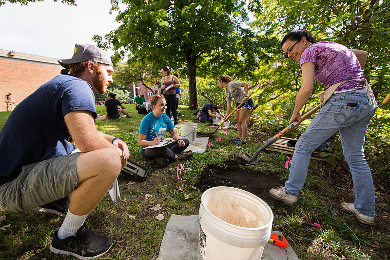Professor of Anthropology Shannon Fie demonstrates to a class proper archaeological techniques on the Beloit College campus. 