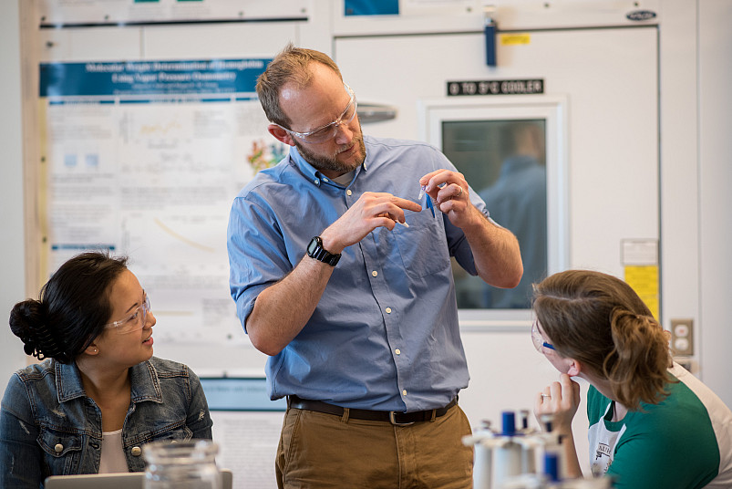 Professor of Chemistry Ted Gries shows students how to perform an experiment in his lab in the Sa...