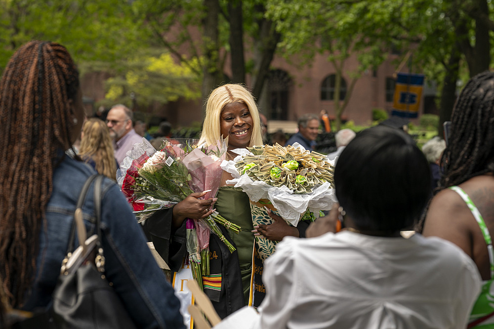 Shakira Wilson receiving armfulls of flowers and bouquets from family and friends.