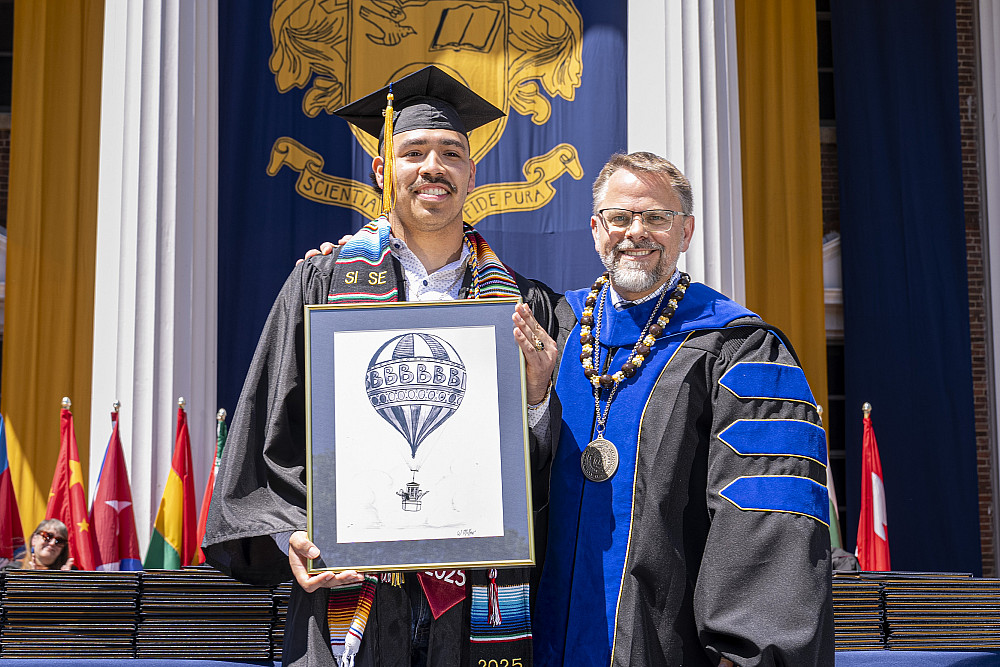 Rafael Cervantes Jr. '25 receiving the Warren Miller Blue Skies award at Beloit College's 2025 Commencement ceremony.