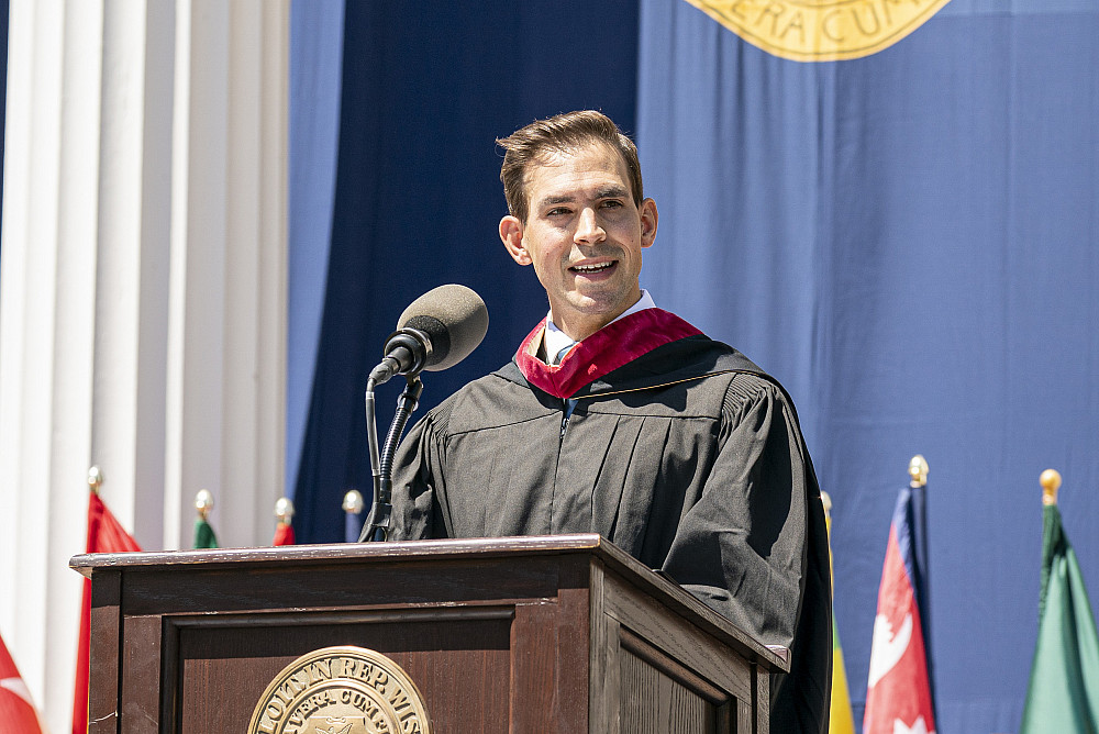 Joe Davis '10 speaks to the graduates at Beloit College's 2025 Commencement ceremony.