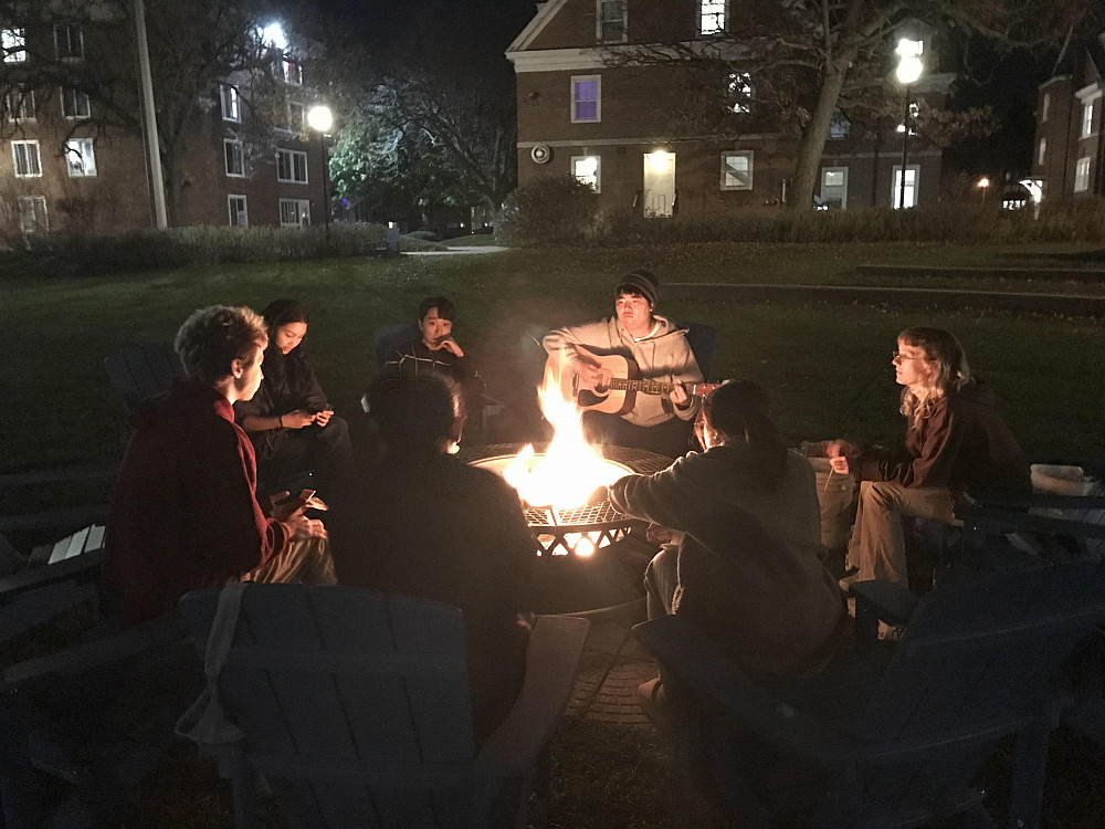 Students enjoy each others' company at a bonfire at Aldrich field.