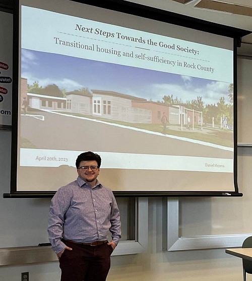 student standing in front of a presentation