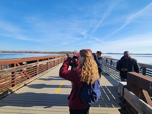 Students use binoculars to see the sites during a nature walk in Madison.