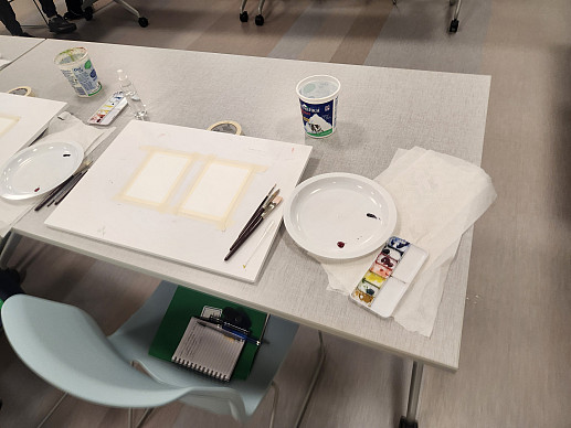 View of a table with paint materials set up.