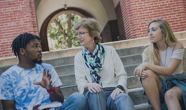 Students and faculty talk on the steps of Beloit College.