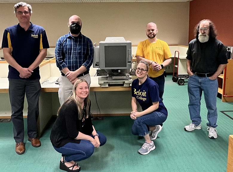 Photo caption: Beloit College Library staff hand the microfilm reader to Beloit Historical Society Assistant Director Jesse Herscher. (Le...