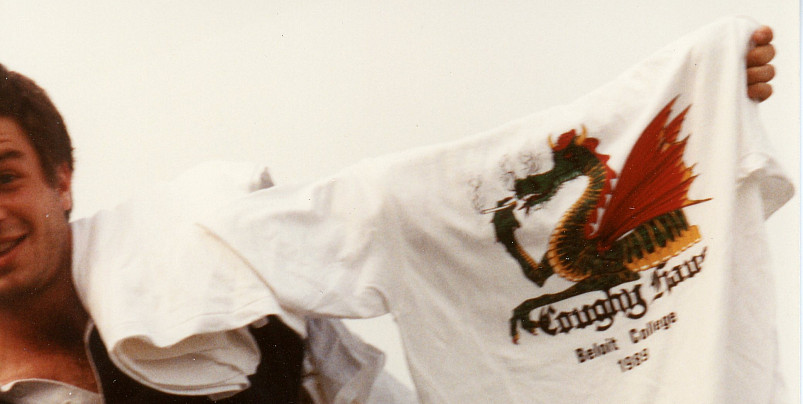 A student shows off a Coughy Haus t-shirt, complete with a smoking dragon logo, 1999.