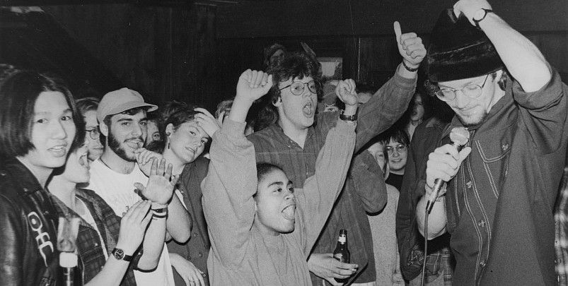 Black and white photograph of students enjoying a live performance in the C-Haus basement, 1989.