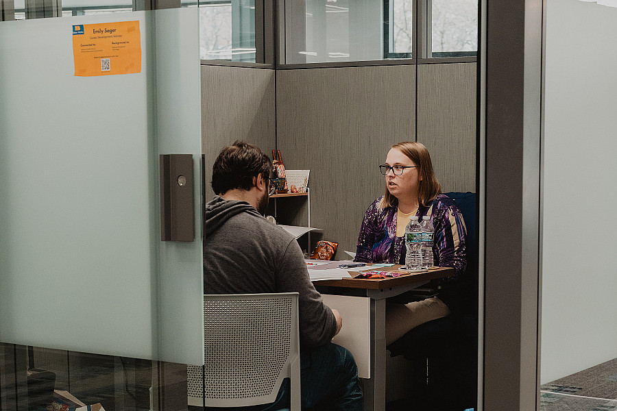 Staff member and student meet in office