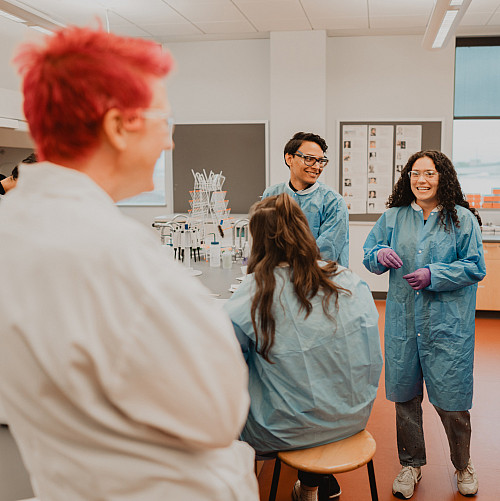 A student asks explains a result in a cell biology lab session.