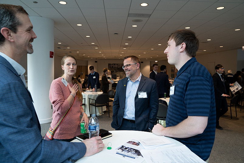 President Eric Boynton talking with alumni and student at Business Networking Summit 2024