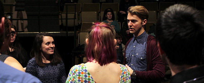 Guest artist Nic Gareiss works with students during a rehersal.