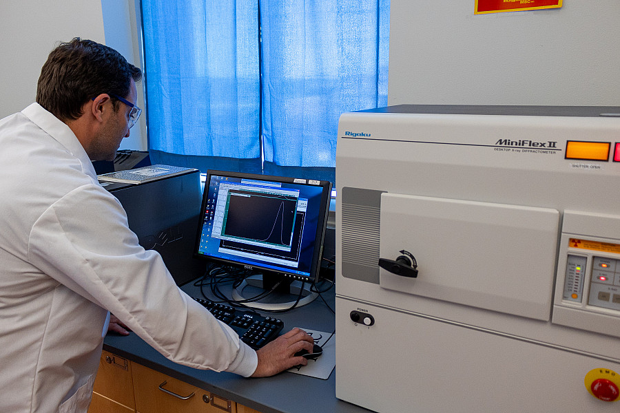 A professor using a X-Ray diffraction instrument.
