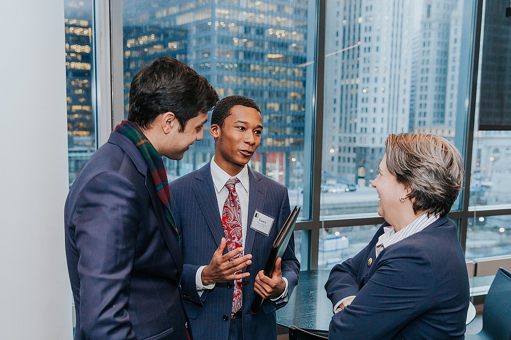 Students speak with a Beloit College alumni at Econ Day.