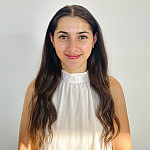 picture of a woman in a white shirt with a blank wall behind