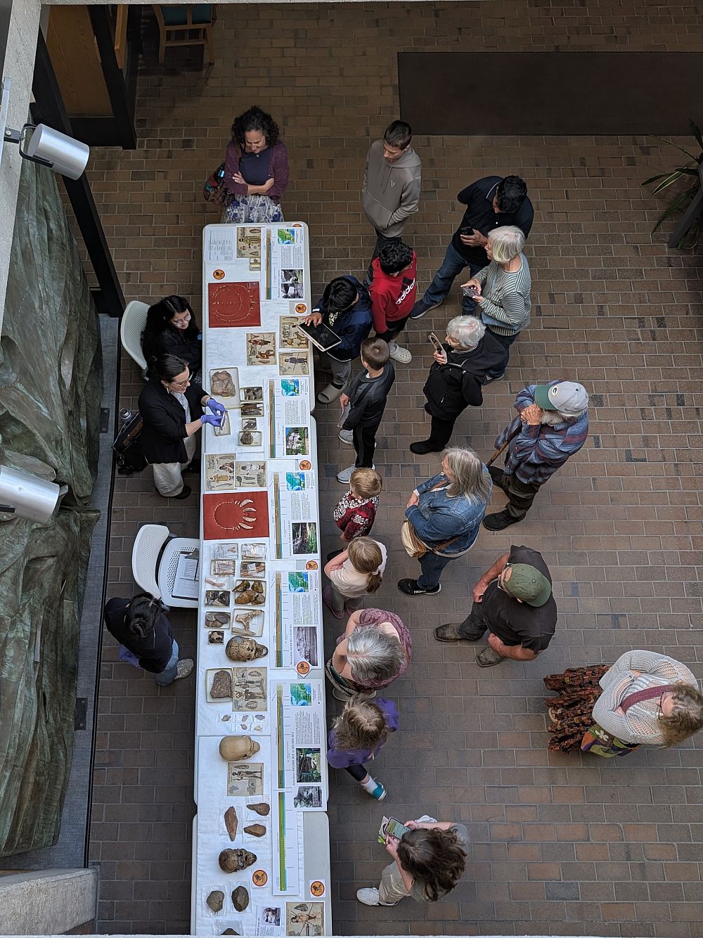 Beloit College students Enigma Calvaria and Marino Komai assist with the exhibit and community engagement.