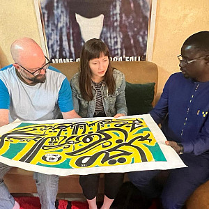 Fig. 3 Derosier, Story, and Ndiaye looking at Fall’s work