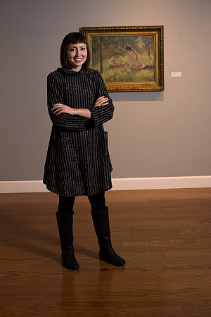 Christa Story in front of painting by Ada Shulz at the Wright Museum of Art.